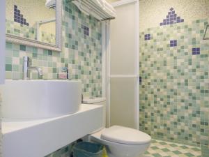 a bathroom with a toilet and a sink at Kenting Sin Sin Hotel II in Kenting