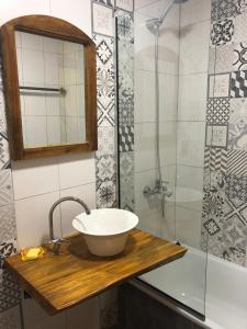 a bathroom with a sink and a glass shower at Portón Rojo in Yatay