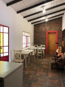 a dining room with tables and chairs and a brick wall at Portón Rojo in Liebig