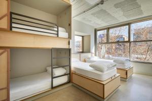 a room with a couch, chair, and a window at Unite Hostel Barcelona in Barcelona