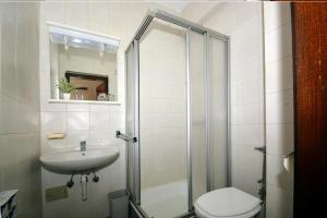 a bathroom with a shower and a toilet and a sink at Guesthouse Kamen Kuća in Podstrana +43 photos