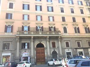 a large building with cars parked in front of it at Bakirooms in Rome