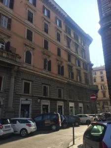 a large building with cars parked in front of it at Bakirooms in Rome