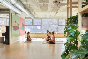 a group of people sitting in a yoga class at Unite Hostel Barcelona in Barcelona