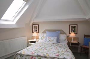 a bedroom with a large bed with two lamps at Windermere Lynwood Guest House in Windermere