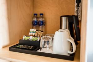 a coffee maker on a shelf in a hotel room at Copenhagen Airport Hotel in Dragør