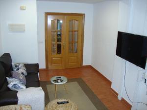 a living room with a couch and a flat screen tv at Balcón curva de Estafeta - Centro in Pamplona