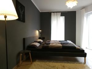 a bedroom with a bed and a lamp and a window at Gästewohnung Hygge in Oldenburg
