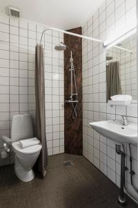 a bathroom with a toilet and a sink at Copenhagen Airport Hotel in Dragør
