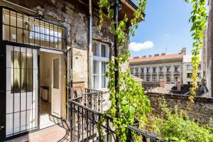 an open door to a building with ivy at Apartment Riverside Molnar26 in Budapest