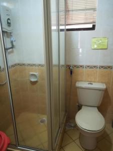 a bathroom with a toilet and a shower at HP Vacation Marina Court in Kota Kinabalu