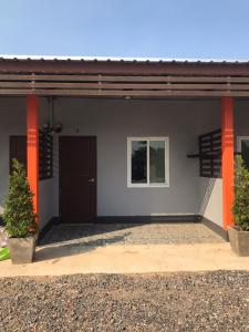 a building with orange columns and a door at Np THE PAI Resort นครสวรรค์ in Ban Pak Nam Pho