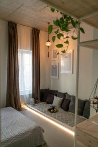 a living room with a couch and a bed at Mai Ram Yoga House in Vilnius