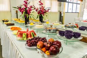 a buffet with many plates of fruit on a table at Pousada Paraiso in Guanambi
