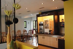un restaurante con barra y una zona de comedor con sillas en Bel Hotel, en Saint-Nicolas-de-Redon
