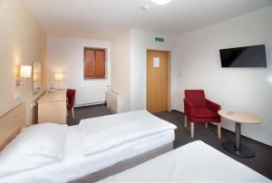Posteľ alebo postele v izbe v ubytovaní Hotel Chvalská Tvrz