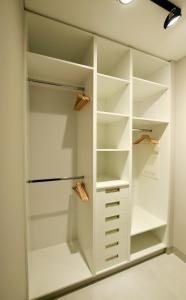 a walk in closet with white cabinetry at Jewish Quarter Comfort - In City Apartments in Krakow