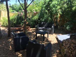 a yard with chairs and a chair and a couch at Residence Pezza Cardo in Porto-Vecchio