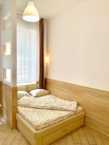two beds in a room with a window at Апартаменти для пари в центральній частині Львова in Lviv