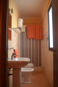 a bathroom with two toilets and a sink at B&B San Domenico in Realmonte