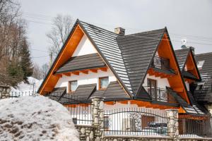 a house with an orange and black roof at Willa 35 in Leśnica