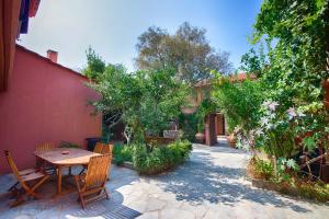 a patio with a table and chairs next to a building at The Varos Residences Hotel in Város