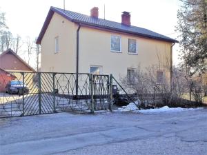 a house with a gate in front of it at Excelent apartment with garden and free parking in Rīga