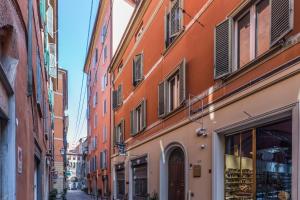 an alley in an old city with buildings at De' Fusari, Bologna by Short Holidays in Bologna