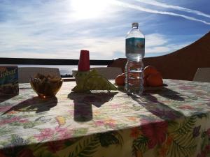 a table with a bottle of water on top of it at Panoramicissima in Costa Rei