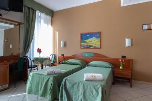 Posteľ alebo postele v izbe v ubytovaní Hotel Dorè