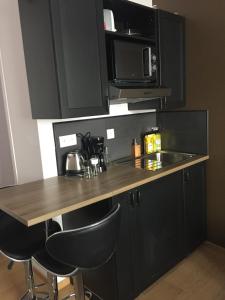 Kuchyň nebo kuchyňský kout v ubytování Appart'hôtel et chambres Lens
