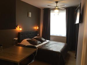 Postel nebo postele na pokoji v ubytování Appart'hôtel et chambres Lens