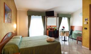 Posteľ alebo postele v izbe v ubytovaní Hotel Dorè