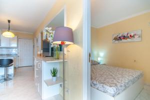 a bedroom with a bed and a purple lamp at EL DORADO SEA VIEW 2A015 in Arona