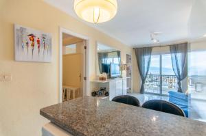 a kitchen and living room with a table and chairs at EL DORADO SEA VIEW 2A015 in Arona