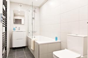 a white bathroom with a toilet and a sink at Juniper Cottage in Bakewell +45 photos