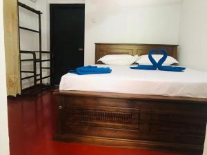 a bed with a blue ribbon on top of it at VILLA 826 Ahungalla in Ahungalla
