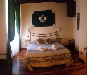 a bedroom with a bed with two pillows on it at Diapason Colosseo Suite in Rome