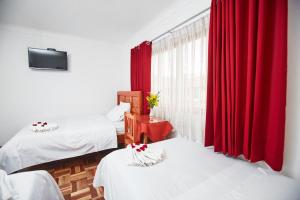 Postel nebo postele na pokoji v ubytování Hostal Danna Inn