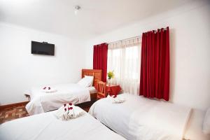 Postel nebo postele na pokoji v ubytování Hostal Danna Inn