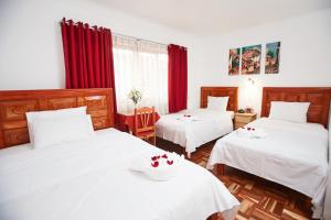 Postel nebo postele na pokoji v ubytování Hostal Danna Inn
