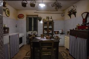 a kitchen with a table and some chairs in it at Locanda della Casella in Cineto Romano