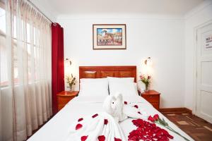 Postel nebo postele na pokoji v ubytování Hostal Danna Inn