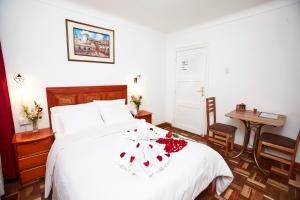 Postel nebo postele na pokoji v ubytování Hostal Danna Inn