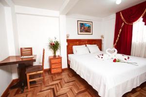 Postel nebo postele na pokoji v ubytování Hostal Danna Inn