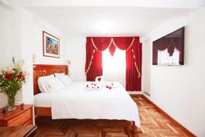 Postel nebo postele na pokoji v ubytování Hostal Danna Inn