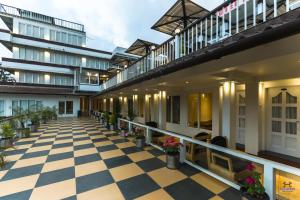 an indoor courtyard of a building with a checkered floor at Darshan Resorts Pvt ltd in Ooty