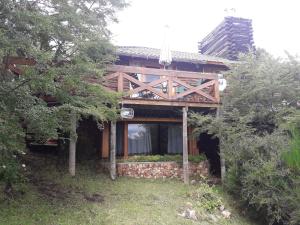 a wooden house with a porch on top of it at Cabañas & Lofts Las Terrazas in Villa Pehuenia