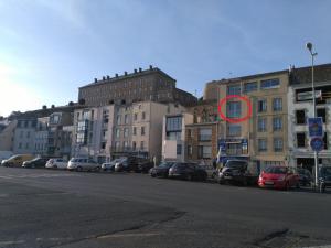 a red circle is on the side of a city street at La Vigie sur le Port in Granville