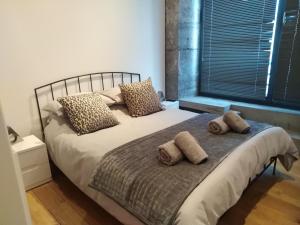 a bed with two pillows on it in a bedroom at Royal William Yard Apartment in Plymouth